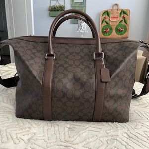 Coach Brown/Black Signature Coated Canvas and Leather Voyager Bag.